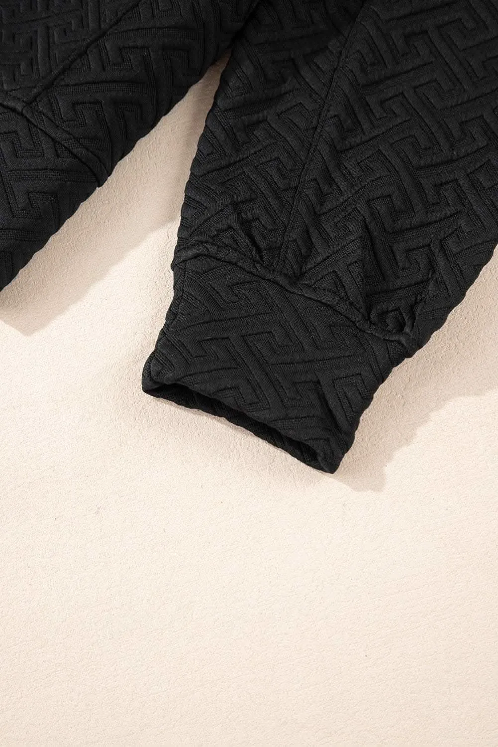 Textured black half-zip sweatshirt